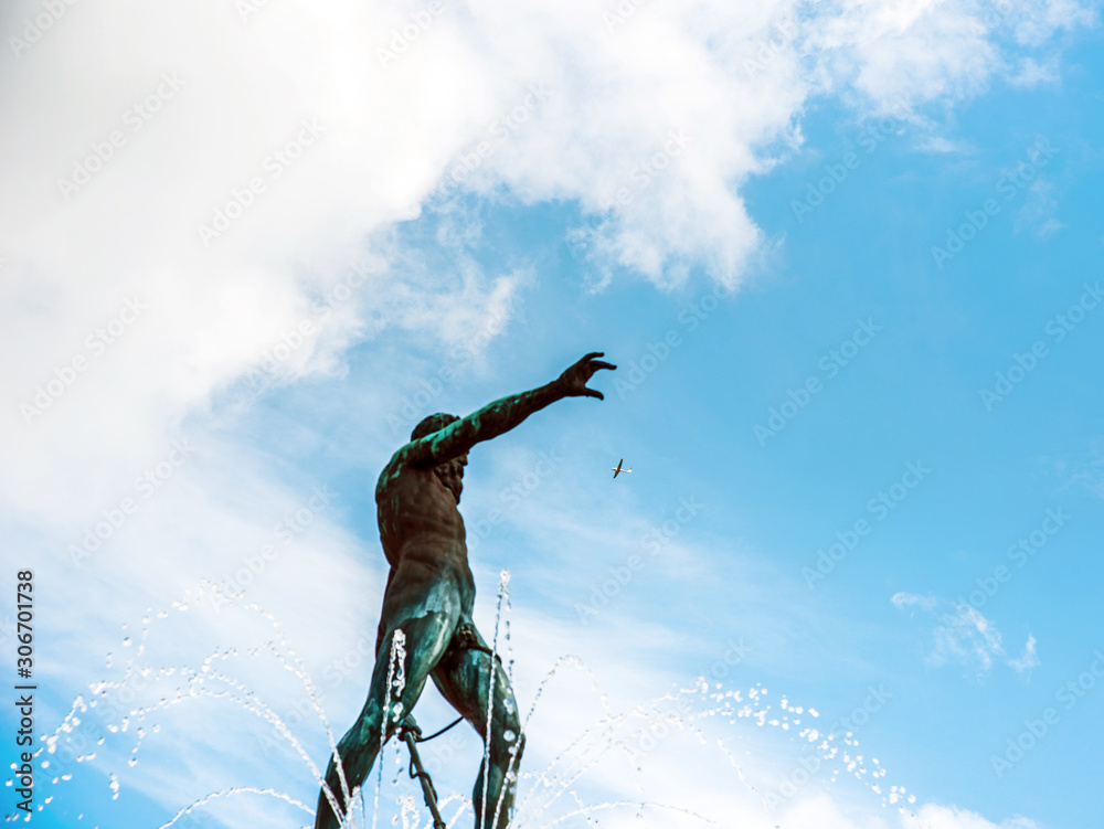 Abstract image of a plane in the sky that Neptune is trying to catch against the background of dynamic clouds in the sky and fountain storms