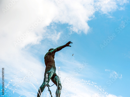 Obraz na płótnie Abstract image of a plane in the sky that Neptune is trying to catch against the background of dynamic clouds in the sky and fountain storms w salonie