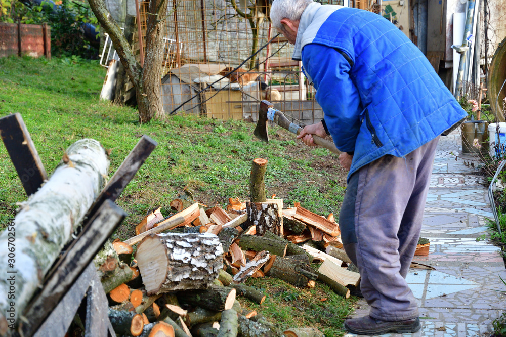 Traditional way of chopping wood with an ax in the village Traditional way of chopping wood with an ax in the village