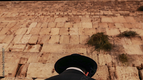 A religious man prays and lays his head on the Western Wall in Holy Jerusalem.