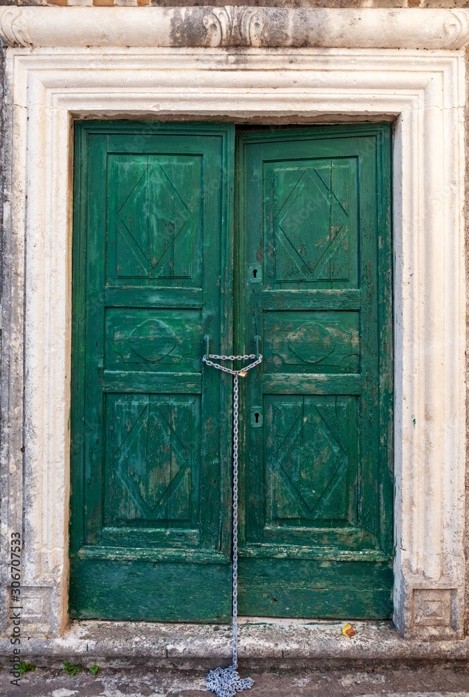 old wooden door in stone wall, background, Perast, Montenegro