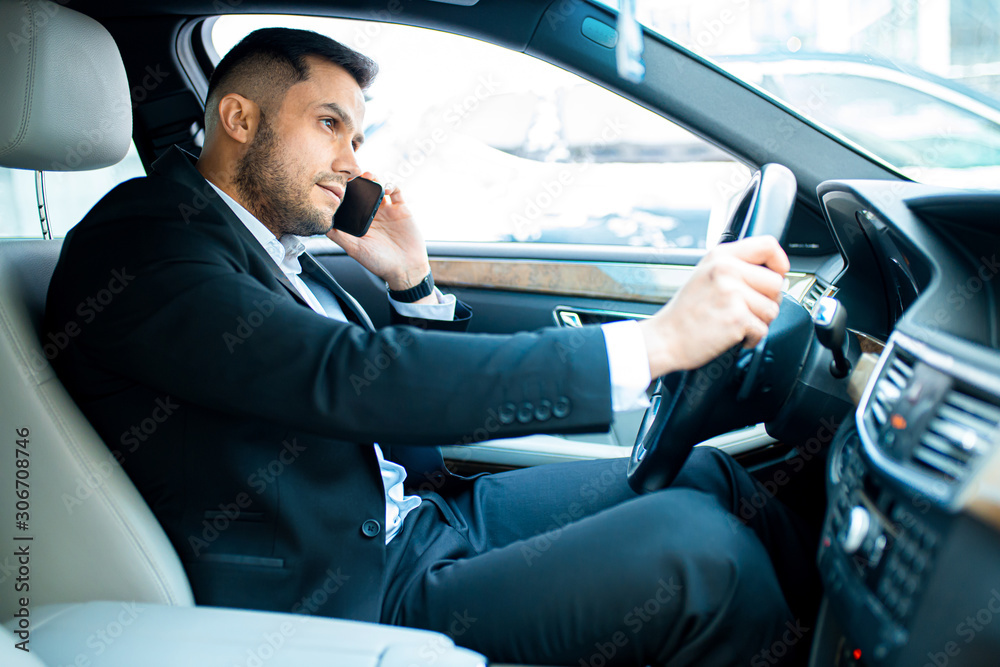 modern lifestyle. handsome young man in tux sit looking side in his own executive car. business people concept modern lifestyle. handsome young man in tux sit looking side in his own executive car. business people concept