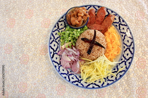 Rice Seasoned with Shrimp Paste (khaao khlook gabpi ) in Thai Blue Plate on the table.Thaifoodmaster’s Professional Thai . photo