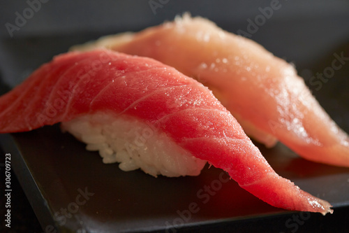 Bonito and tuna sushi on black plate 