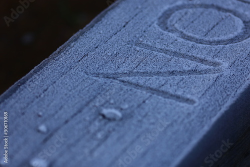"NO" printed in frosty snow on public bench outside © wideshuts