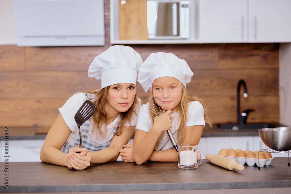 cunning adult and kid girl think about future baking, cooking together, teamwork of child and mother cunning adult and kid girl think about future baking, cooking together, teamwork of child and mother