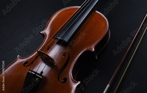 The abstract art design background of wooden violin put on background,show front side of string instrument,on black canvas background