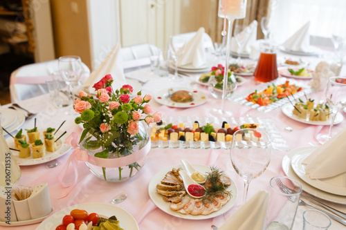 Served for banquet restaurant table with dishes, snack, cutlery, wine and water glasses, european food, selective focus