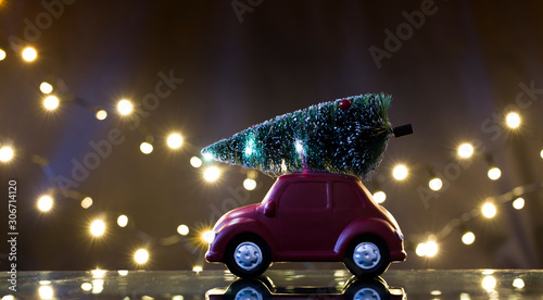 Retro toy car with Christmas tree. Holiday background for greetings.