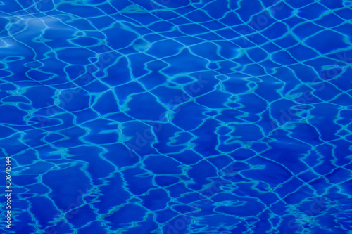 Blue swimming pool water ripple background. © Sekson