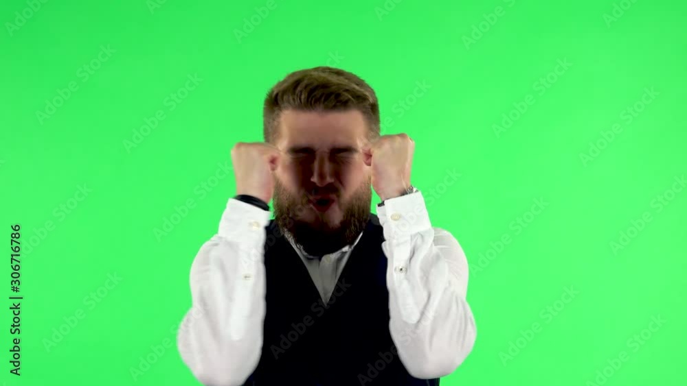 Man looking at the camera with excitement, then celebrating his victory triumph on green screen Man looking at the camera with excitement, then celebrating his victory triumph on green screen