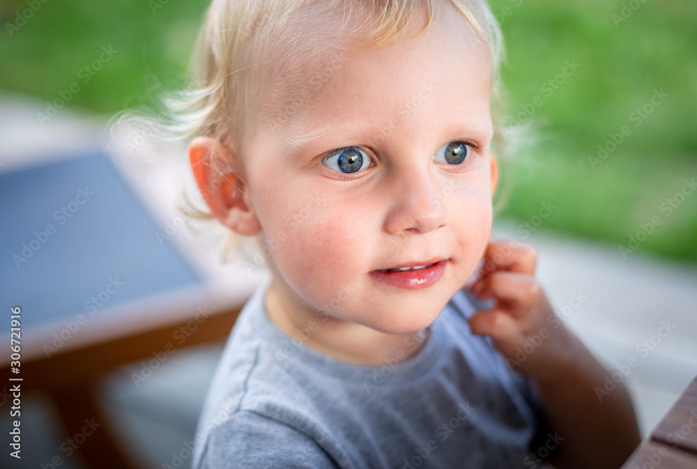 Portrait of cute little child boy with blond hair and blue grey eyes Portrait of cute little child boy with blond hair and blue grey eyes