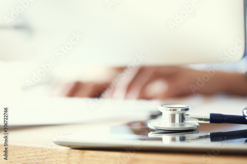 Medicine doctor's writing on keyboard in medical office close-up.