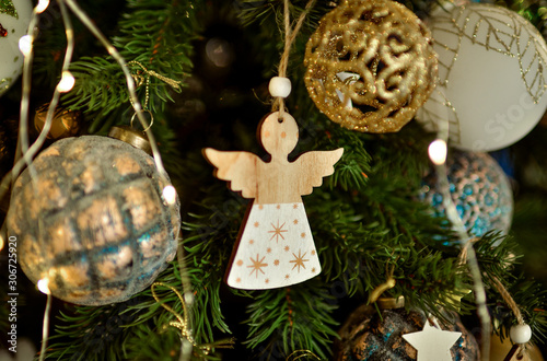  Christmas angel. Toy angel made of wood hanging on a Christmas tree. New Year's decor.