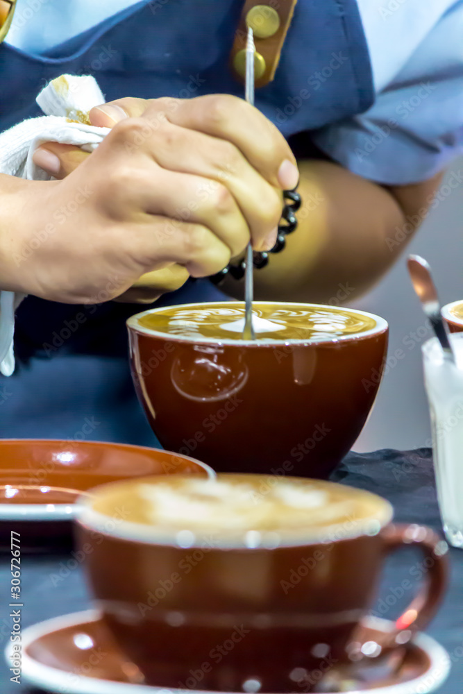 Showcase Barista making Latte art coffee and Barista pouring fresh milk create art pattern on Latte coffee at cafe. Showcase Barista making Latte art coffee and Barista pouring fresh milk create art pattern on Latte coffee at cafe.