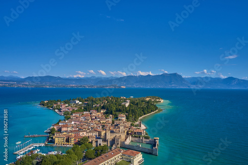 Unique view. Aerial photography, the city of Sirmione on Lake Garda north of Italy. In the background is the Alps. Resort place. Aerial view. 