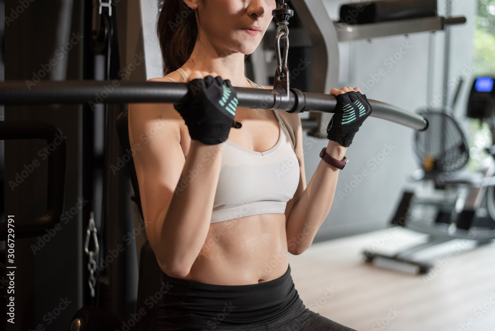 Beautiful asian woman is doing exercise in the gym Beautiful asian woman is doing exercise in the gym