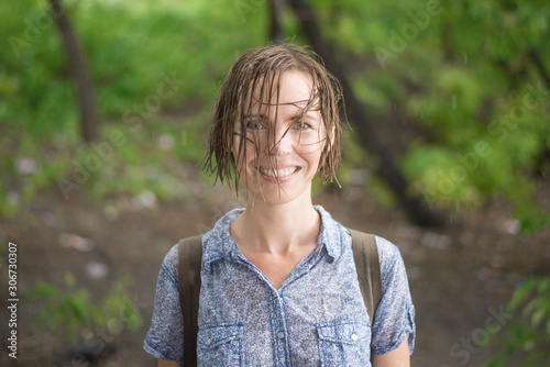 drenched woman in the rain forest in summer photo