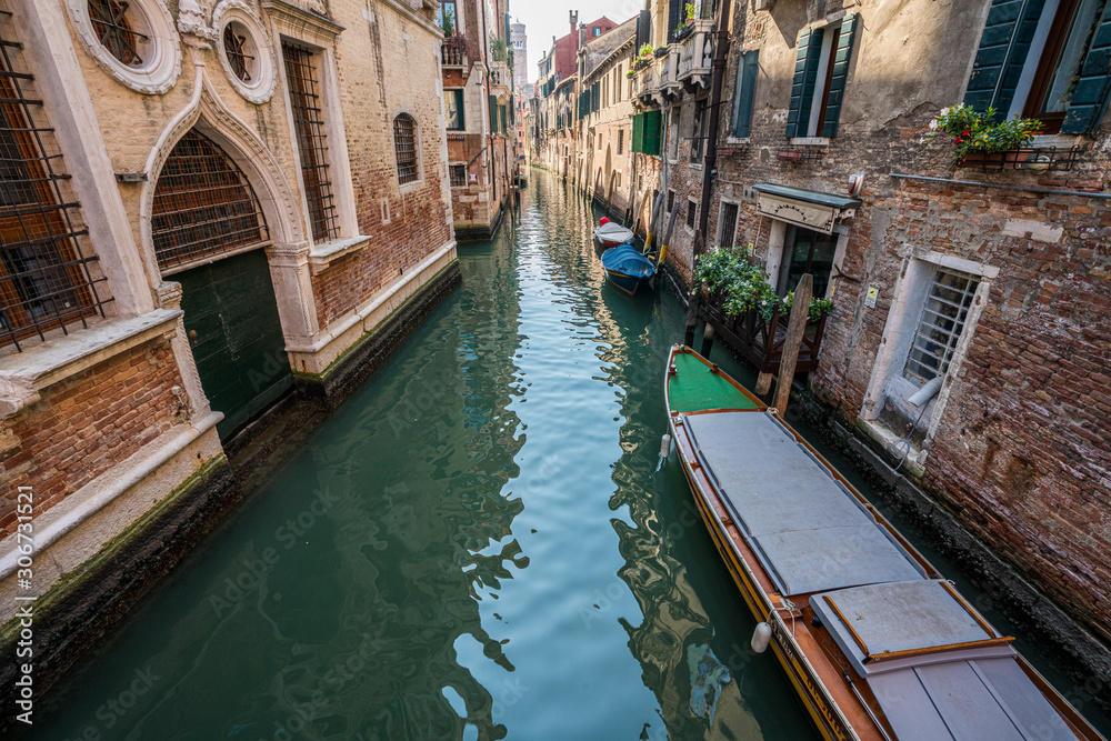 Venice canal with venetian boats in Venice, Italy