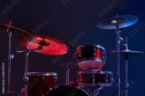 professional drum set instruments in dark studio with lights . music, instruments, hobby concept