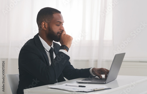Young african american businessman studying market online