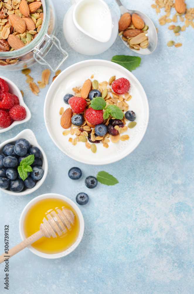 Homemade granola with yogurt and fresh berries, healthy breakfast concept, top view, flat lay. Homemade granola with yogurt and fresh berries, healthy breakfast concept, top view, flat lay.