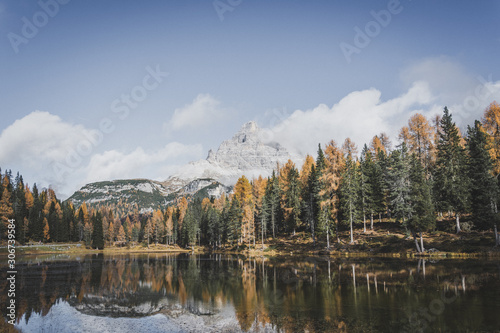 Moutnain above forest, autumn at the lake in Dolomites Italy