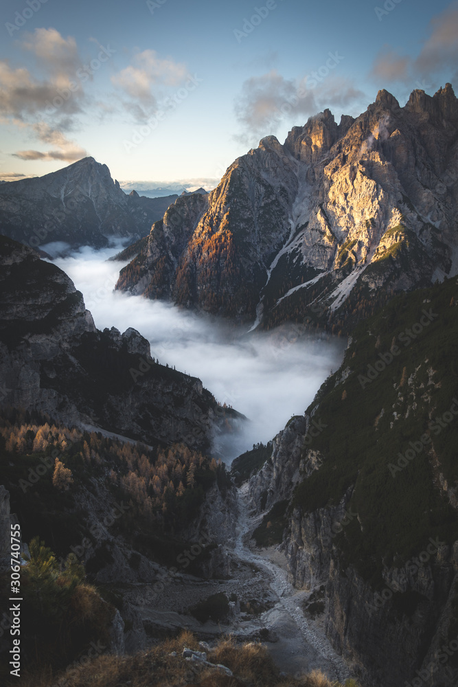 Dolomites, Italy, autumn sunrise valley landscape with cloud inversion