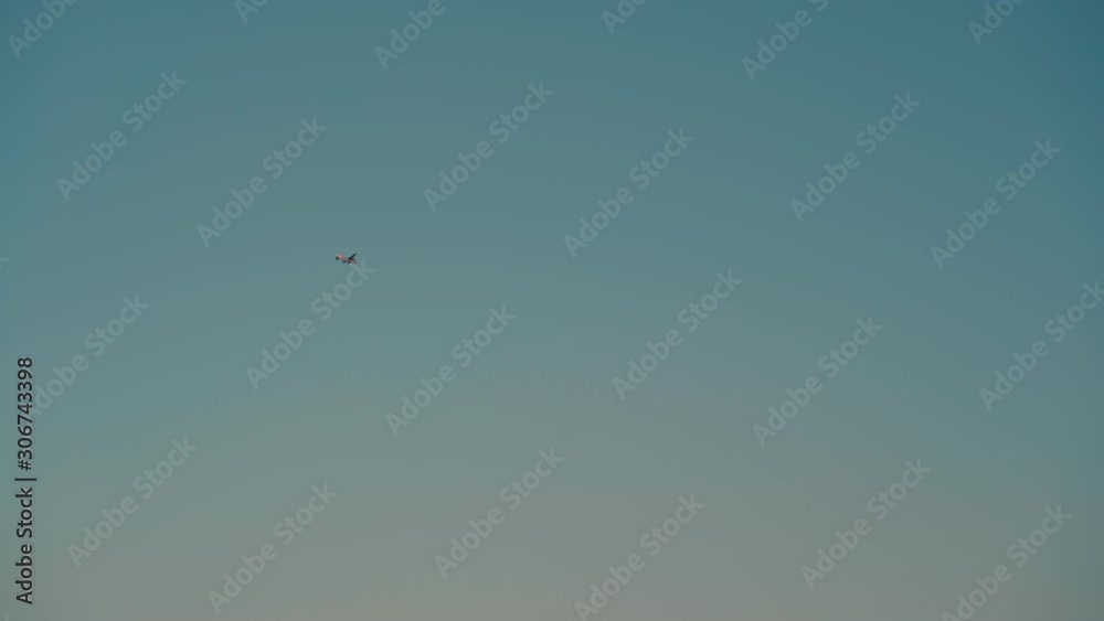 modern small airplane flies in boundless clear blue sky in nice autumn evening view from ground modern small airplane flies in boundless clear blue sky in nice autumn evening view from ground