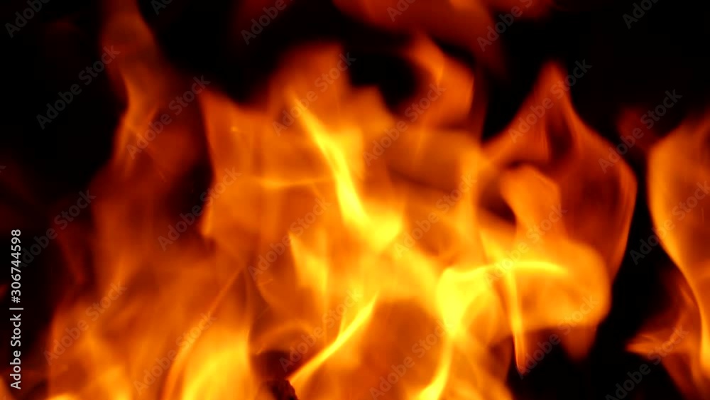 Fascinating magic of fire. Orange flames lick the charred crackling and emitting sheaves of sparks of logs. Fascinating magic of fire. Orange flames lick the charred crackling and emitting sheaves of sparks of logs.