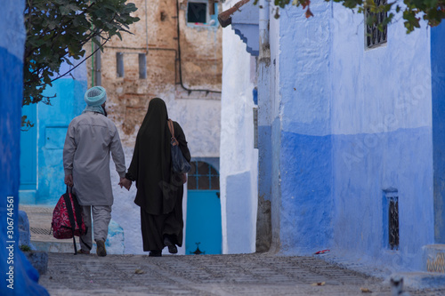 Couple walking in the blue city of Chefchaouen, Morocco © urdialex