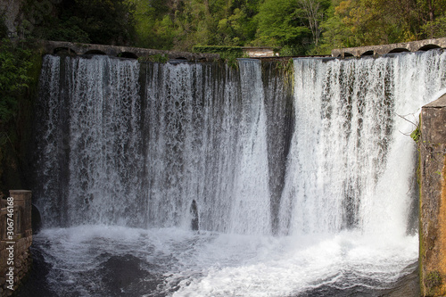 The waterfall is wide in the mountains. Beautiful water falls from the top, dam. Tourist place.