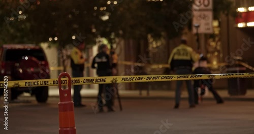 Police tape across a street at an urban crime scene