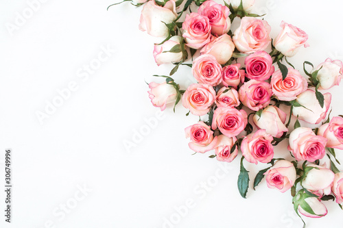 Floral composition with pink rose flower buds on white background. Flat lay, top view.