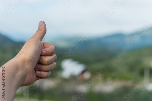 Approved sign of hand with natural enviroment at the background