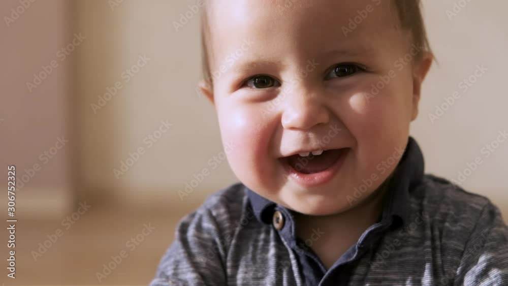 Cute baby smiling and looking at camera close up on the face. Cute baby smiling and looking at camera close up on the face.