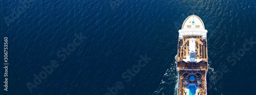 Aerial drone panoramic photo of huge cruise liner ship with top deck swimming pool cruising open ocean sea photo
