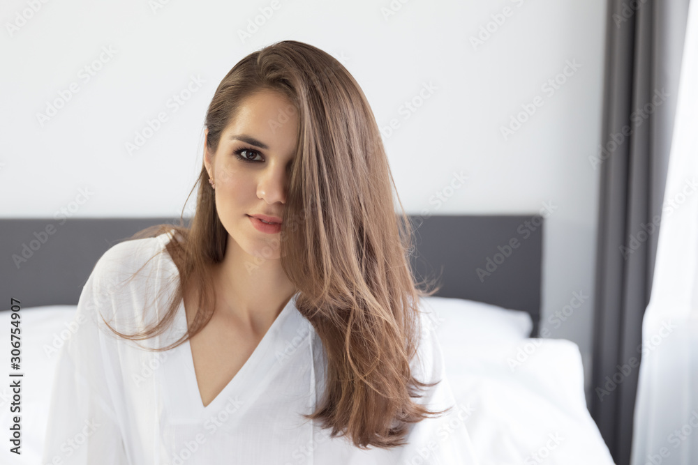 Woman enjoying morning awakening in a soft snow-white bed. Woman enjoying morning awakening in a soft snow-white bed.