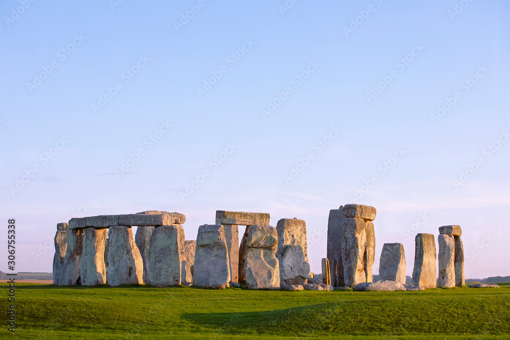 Stonehenge, clear evening sky. Prehistoric monument in Wiltshire, England. Historic Neolithic Stones. No people.