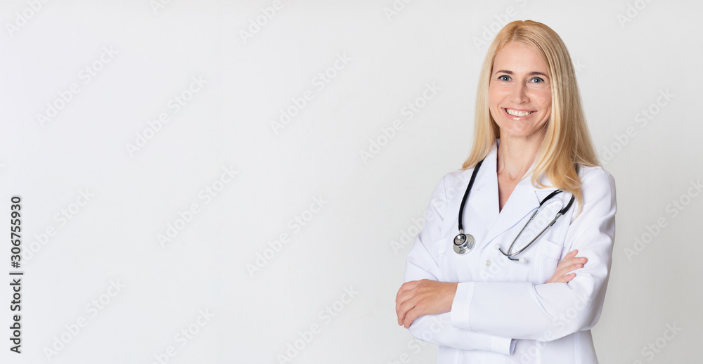 Healthcare concept. Middle-aged woman doctor in uniform - obrazy, fototapety, plakaty 
