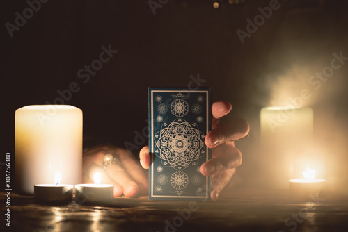Fortune teller with tarot cards in hands close up. Future reading concept.