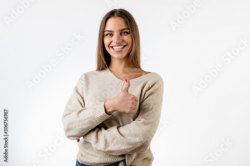 beautiful smiling woman showing thumbs up isolated over white