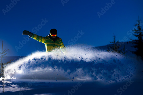 Snowboarder Riding Snowboard in the Forest at Night. Snowboarding and Winter Sports