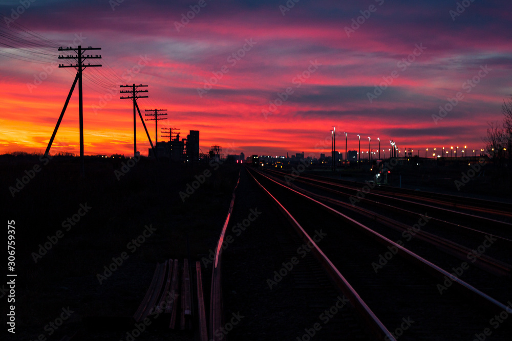 Shining Railway Tracks at a Fiery Sunset