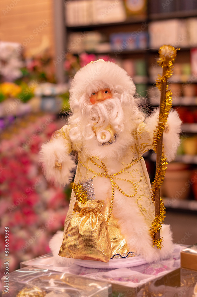 Santa Claus with  beard and with  stick in New Year, toy. Front view.