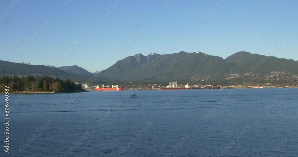 float plane landing on water in front of stanley park float plane landing on water in front of stanley park