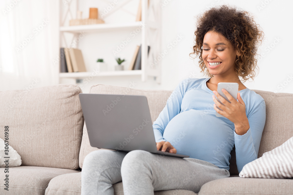 Happy expectant woman using technology devices at home Happy expectant woman using technology devices at home