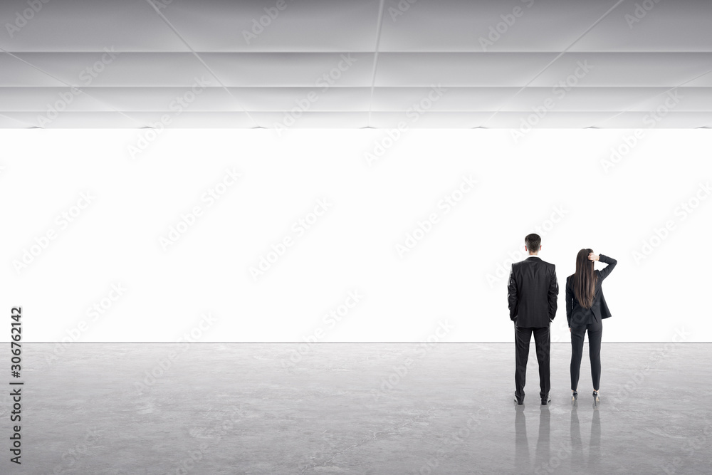 Businessman and businesswoman in gallery interior Businessman and businesswoman in gallery interior
