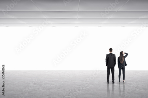 Businessman and businesswoman in gallery interior