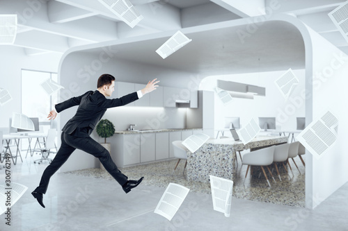 Businessman jumping in office